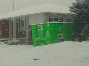 Dumpster On Snowy Driveway